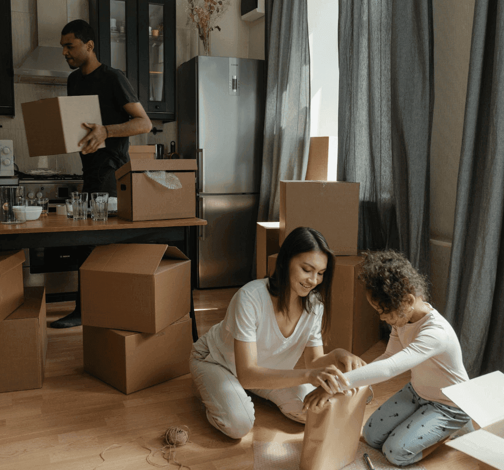 Professional handing house keys to a couple in front of their new home